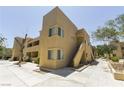 Beige two-story condo building with a sidewalk leading to the apartment doors at 1836 N Decatur Blvd # 203, Las Vegas, NV 89108