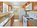 Bright kitchen features tile floors, granite counters, and stainless-steel appliances at 1836 N Decatur Blvd # 203, Las Vegas, NV 89108