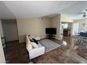 The living room features tile floors, a comfortable couch, and a view of the kitchen at 2362 Sierra Sunrise St, Las Vegas, NV 89156