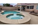 Relaxing backyard featuring a private pool, hot tub, and well-kept patio at 2707 Gardenia Flower Ave, North Las Vegas, NV 89031
