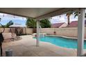 Inviting backyard features a sparkling pool, spa, and covered patio area at 2707 Gardenia Flower Ave, North Las Vegas, NV 89031