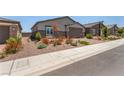 Street view of a modern home exterior featuring low maintenance desert landscaping and neutral color palette at 288 Whitney Crest St, Henderson, NV 89015