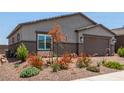 Charming home exterior showcasing desert landscaping, a two-car garage, and a welcoming facade at 288 Whitney Crest St, Henderson, NV 89015