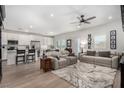 Open-concept living room featuring modern furniture, neutral tones, and lots of natural light at 288 Whitney Crest St, Henderson, NV 89015