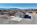 Expansive aerial view showcasing a home with an attached garage and a detached garage with mountain views at 3580 Prairie Ave, Pahrump, NV 89048