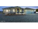 Eye-catching single story home featuring a three car garage, desert landscaping, and ample parking at 3580 Prairie Ave, Pahrump, NV 89048