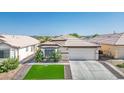 Inviting single-story home with a two-car garage, manicured lawn, and lush green shrubbery at 4529 Gracemont Ave, Las Vegas, NV 89139