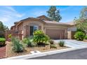 Single-story home featuring a two-car garage and desert landscaping with mature shrubs at 4937 Graziano Ave, Las Vegas, NV 89141
