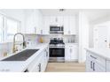 Modern kitchen with white cabinets, stainless steel appliances, and stylish backsplash at 5264 Silverheart Ave, Las Vegas, NV 89142
