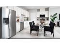 Modern kitchen with stainless steel appliances, white cabinetry, and a dining area perfect for Gathering meals at 641 Bellus Pl # Lot 149, Henderson, NV 89015