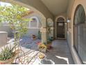 Inviting front entrance with a covered porch and decorative plants and exterior lighting at 800 Antonio Dr, Las Vegas, NV 89107
