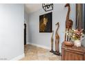 Bright foyer with tiled flooring, decorative art and giraffe statues, and front door access at 800 Antonio Dr, Las Vegas, NV 89107