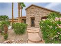 Inviting front entrance with stone accents, mature bushes, and well-maintained landscaping at 8032 Audubon Canyon St, Las Vegas, NV 89131
