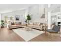 Open-concept living room featuring high ceilings, wood floors, and contemporary furnishings at 9011 Aldershot Ct, Las Vegas, NV 89147