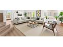 Stylish living room with a large sectional sofa, modern coffee table, and comfortable accent chair at 9011 Aldershot Ct, Las Vegas, NV 89147