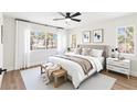 Serene bedroom with a king-sized bed, soft lighting, and a view of palm trees at 9011 Aldershot Ct, Las Vegas, NV 89147