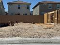 A new home can be built on this empty lot that sits between existing homes and has utility hookups at 9113 Rivington Ave, Las Vegas, NV 89148