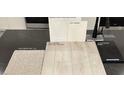 Upgraded design materials include carpet, LVP flooring, and counter top samples with a sleek black kitchen faucet at 9113 Rivington Ave, Las Vegas, NV 89148