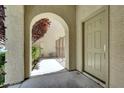 Covered entryway featuring an arched opening and a view of the gated side yard at 9225 Dalmahoy Pl, Las Vegas, NV 89145
