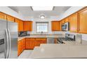 Well-lit kitchen featuring stainless steel appliances and wooden cabinetry at 930 High Plains Dr, Henderson, NV 89002