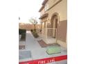 Home exterior featuring stucco walls and manicured landscaping, with a private entrance at 10231 Delray Beach Ave # 201, Las Vegas, NV 89129