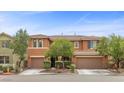 Charming two-story home with well-manicured landscaping and a welcoming front entrance at 10300 S Dapple Gray Rd, Las Vegas, NV 89178
