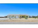 Charming single-story home with a three-car garage and low-maintenance desert landscaping at 1351 Huckleberry St, Pahrump, NV 89048