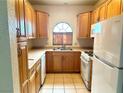 Efficient kitchen featuring oak cabinets, ample counter space, and standard appliances for culinary endeavors at 1409 Santa Margarita St # B, Las Vegas, NV 89146