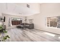 Airy living room showcasing a comfortable gray couch, modern flooring, and ample natural light for a relaxing atmosphere at 1832 Merze Ave, Henderson, NV 89011