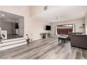 Bright, open living room featuring modern floors, a comfortable couch, and plenty of natural light from the window at 1832 Merze Ave, Henderson, NV 89011