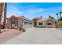 Beautiful home with a well-maintained lawn, three-car garage, and desert-style landscaping at 2102 Rhonda Ter, Henderson, NV 89074
