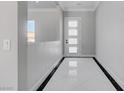 Bright foyer with white tile floors and a modern front door at 2110 S Manzanita Dr, Pahrump, NV 89048
