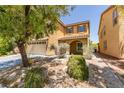 Beautiful exterior of home featuring a two-car garage, desert landscaping, and a covered entry at 212 Stagecoach Flats, Las Vegas, NV 89031