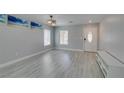 Bright living room with grey walls, light laminate flooring, modern lighting and a front door at 212 Stagecoach Flats, Las Vegas, NV 89031