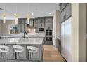 Modern kitchen with gray cabinets, stainless steel appliances, a center island, and pendant lighting at 2194 Pigeon Hawk St, Las Vegas, NV 89138