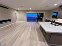 Modern living room with hardwood floors, a cozy fireplace, and large sliding doors to a patio at 2194 Pigeon Hawk St, Las Vegas, NV 89138