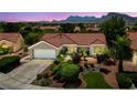 Beautiful home featuring mature desert landscaping, an attached garage and a red tile roof at 2509 Big Timber Dr, Las Vegas, NV 89134