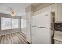 Bright dining area with wood-look floors and a large white refrigerator at 3060 Tarpon Dr # 102, Las Vegas, NV 89120