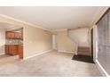 Bright living room featuring neutral walls, plush carpeting, and easy access to the staircase and kitchen at 3189 Pinehurst Dr # B, Las Vegas, NV 89109