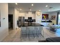 Open kitchen with stainless steel appliances and dark countertops at 3194 Lumassina Way, Henderson, NV 89044
