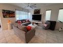 Bright living room with neutral tones, tile flooring, and modern furniture at 3194 Lumassina Way, Henderson, NV 89044