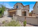 Charming home showcasing a desert landscape, two-car garage, and tile roof with exterior wall at 348 Andy Wheeler Dr, Henderson, NV 89011