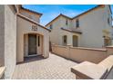 Inviting entryway, featuring a neutral color scheme and paved walkway to the front door at 348 Andy Wheeler Dr, Henderson, NV 89011