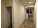 Tiled hallway with an arched ceiling leads into a living space in this home at 4104 Free Bird Crest Ave, North Las Vegas, NV 89081