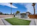 Spacious backyard with a new patch of green grass, perfect for relaxation and outdoor activities at 4831 Vermont Ave, Las Vegas, NV 89107