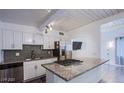 Modern kitchen with stainless steel appliances, granite countertops, and ample cabinet space at 4831 Vermont Ave, Las Vegas, NV 89107