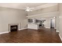 Inviting open-concept space with a fireplace, wood floors, and an adjacent kitchen at 5734 Duval Dr, Las Vegas, NV 89156