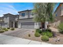 Charming two-story home with a well-maintained front yard and a two-car garage at 6106 Castle Gardens Ave, Las Vegas, NV 89130