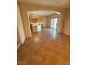Bright living space with sliding glass door leading to the backyard and an adjacent kitchen at 6425 Sierra Sands St, North Las Vegas, NV 89086