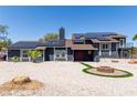 Beautiful two-story home featuring solar panels, double doors, and a charming fire pit area at 7135 Polaris Ave, Las Vegas, NV 89118